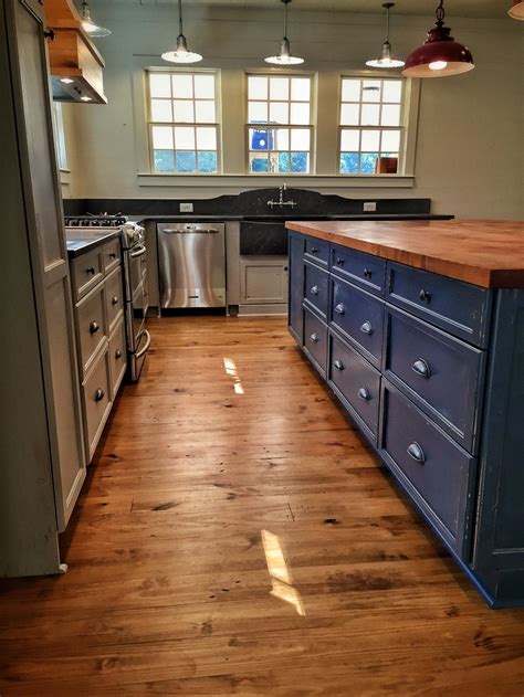 A light blue kitchen cabinet or island can set a cool but cheerful tone for the right space. Farmhouse kitchen with blue island and wood countertop. | Kitchen range hood, Wood countertops ...