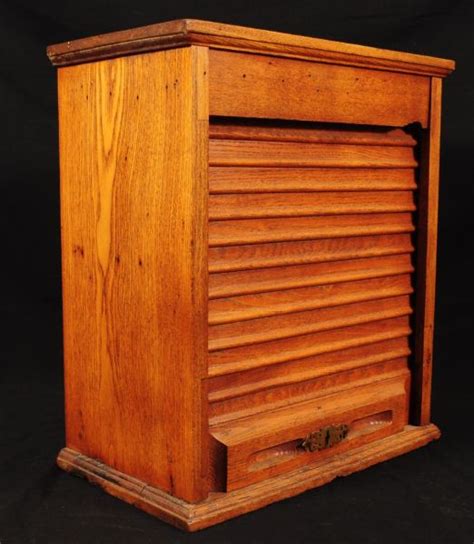 Two drawers with metal runners and safety stops; Oak Rail Road Roll Front Ticket Cabinet