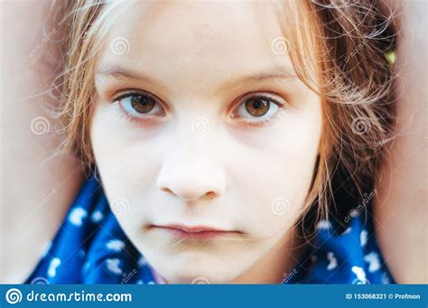 Sad Little Girl Is Looking With Serious Face At Camera Stock Image
