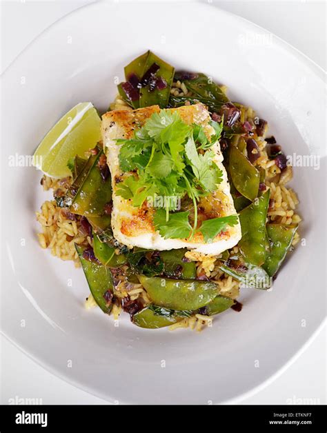 Cod Fish Fillets With Rice And Peas Stock Photo Alamy
