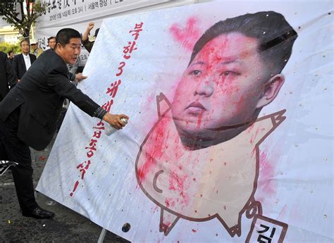 Read more on this topic A South Korean activist paints on a caricature of Kim Jong ...