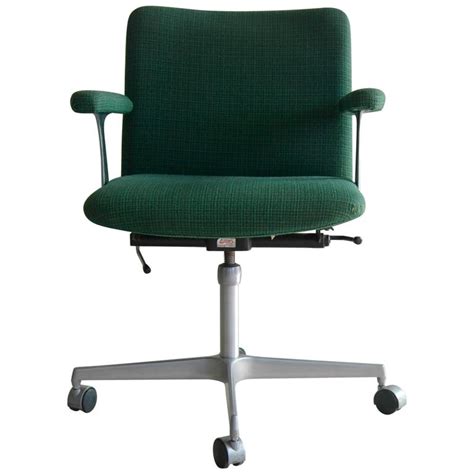 Black fabric upholstery allows air to air circulates through the material, keeping users cool while they work. Ultra-Cool Swivel Office Chair by Cado Design Attributed ...