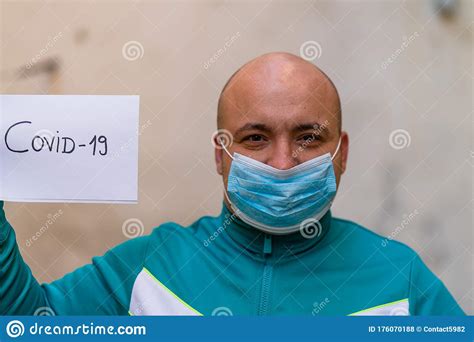 Sick Young Man With Medical Face Mask Close Up Portrait Man Holding