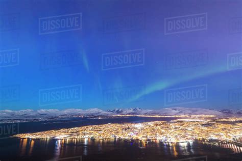 Northern Lights Aurora Borealis On The City Of Troms Seen From
