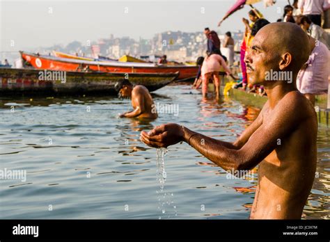 A Pilgrim Is Praying In The Holy River Ganges At Dashashwamedh Ghat Main Ghat In The Suburb
