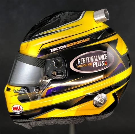 The Helmet Is Yellow And Black With Silver Accents On Its Face While