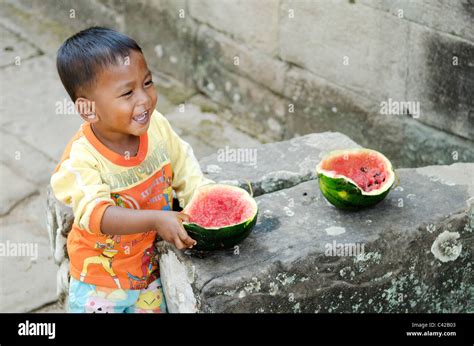 Asian Child Eating Watermelon Fruit In Cambodia Stock Photo Alamy