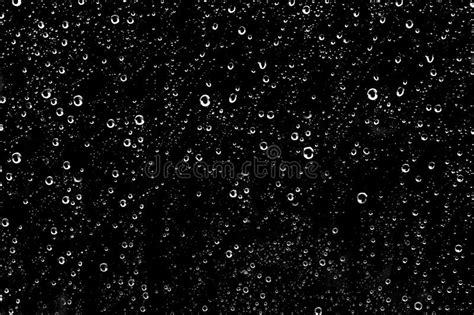 Hundreds Of White Rain Drops On A Window With A Black