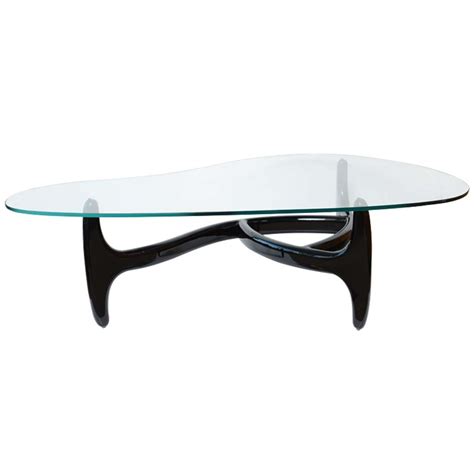 This short heighted coffee table has a narrow flat base that provides it a good stability on the ground. Designer Architectural Kidney Shaped Coffee Table at 1stdibs