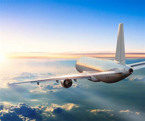 Airplane Flying Above Clouds In Dramatic Sunset Stock Image Image Of