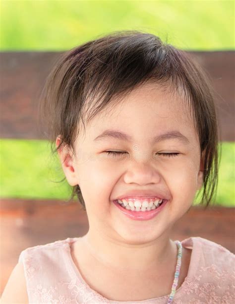 Portrait Of Four Years Old Happy Laughing Asian Girl Little