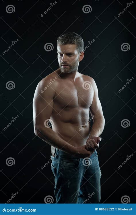 Handsome Man With Muscular Body And Serious Unshaven Face Stock Photo