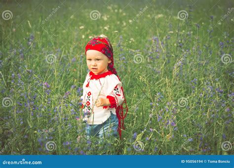 Cute Toddler Girl With Funny Face In A Meadow Stock Photo Image Of