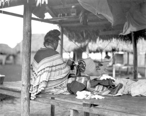 Florida Memory Seminole Woman Sewing And Tending Baby In Hammock