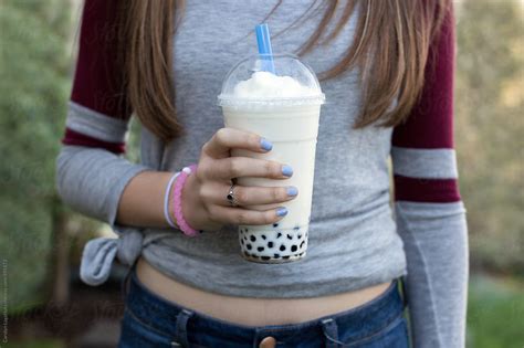 Teen Girl Holding A Bubble Tea Or Boba Drink By Stocksy Contributor
