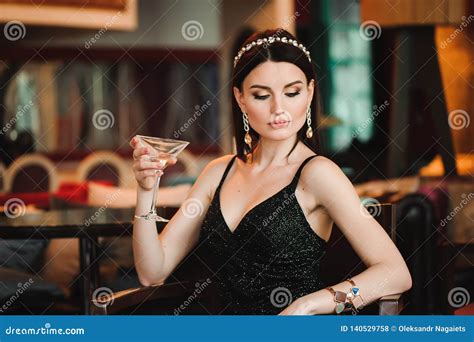 Portrait Of Beautiful Woman Holding Glass Of Martini Stock Photo