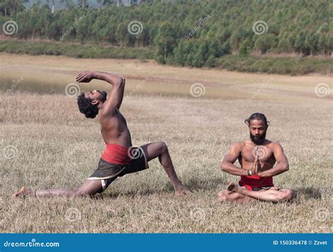 Indian Men Doing Yoga Exercise On Green Grass In Kerala South India