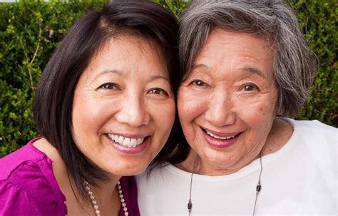 Smiling Mature Asian Mother And Her Adult Daughter