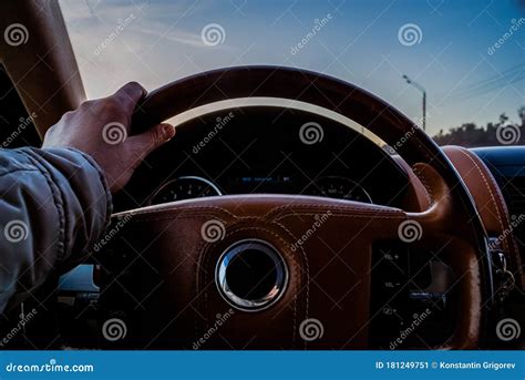 Male Hand Holds The Steering Wheel Of A Car Close Up View Of The