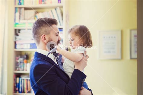 Young Father Hugging His Daughter As He Gets Home From Work Royalty Free Stock Image Storyblocks