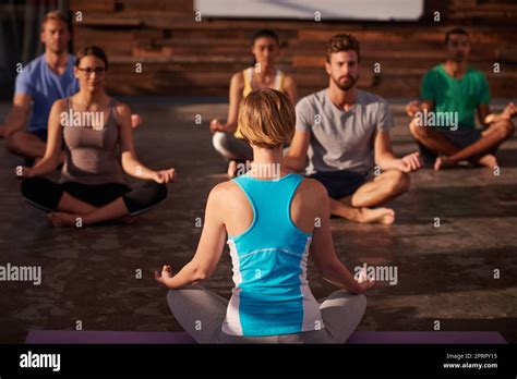 Stress free zone. a yoga instructor instructing her class Stock Photo