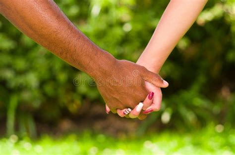 Arms Of Interracial Couple Holding Hands Great Love Symbolic Concept Green Garden Background