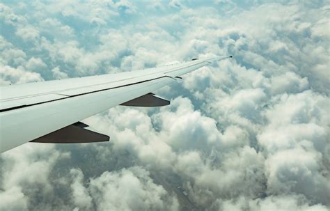 Premium Photo Wing Of Plane Over White Clouds Airplane Flying On