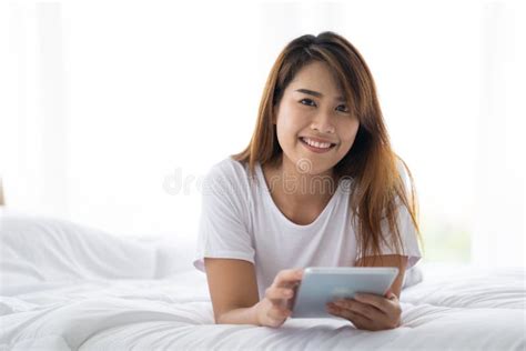 Portrait Of Beautiful Asian Woman Lying On Bed Enjoy Using Tablet Young Lady Resting In Bedroom