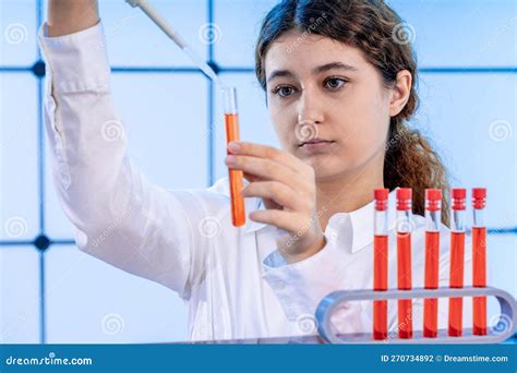 Young Adult Female Student In A Science Laboratory With Chemical