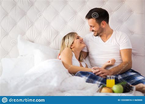 Young Couple Having Having Romantic Times In Bedroom Stock Photo - Image of attractive, pajamas ...