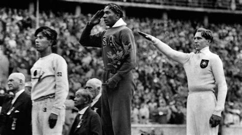 Jesse Owens Salutes The American Flag After Winning A Gold Medal At The 1936 Berlin Olympics