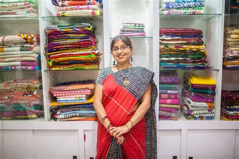 A Businesswoman Who Sells Traditional Indian Dress In A Small Shop By