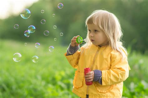 See if he enjoys that too! Adorable Baby Blow Soap Bubbles In Park Stock Photos ...