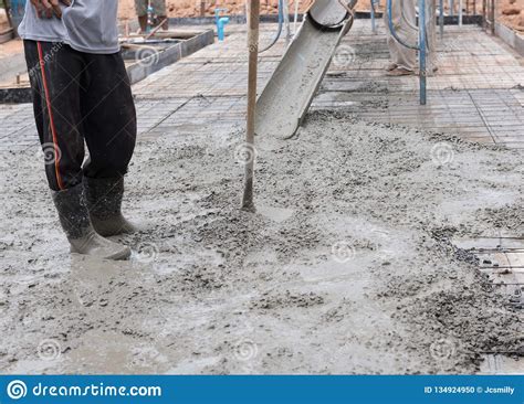 Man Workers Spreading Freshly Poured Concrete Mix On Building Stock