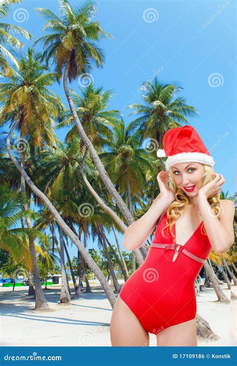The Girl In A Bathing Suit And A Cap Of Santa Clau Royalty Free Stock