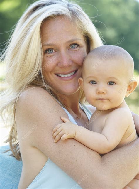 Smiling Mother Holding Baby Outdoors Stock Image F004 9401