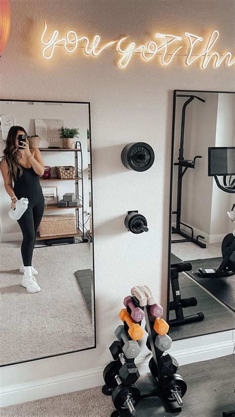 A Woman Taking A Selfie In Front Of A Mirror With Dumbs And Exercise