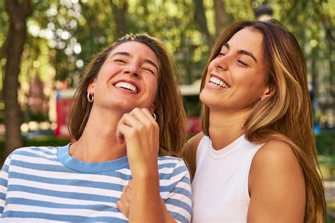Premium Photo Two Women Laughing Together In A Park