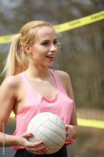 Joyful Sexy Blond Girl Playing Volleyball Outdoors On The Lakesi Buy
