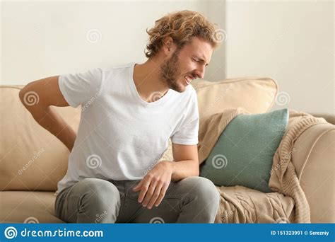 Young Man Suffering From Back Pain At Home Stock Image Image Of Sick