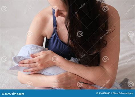 Mom Holds Her Newborn Baby In Her Arms Portrait Of A Boy Or Girl Close