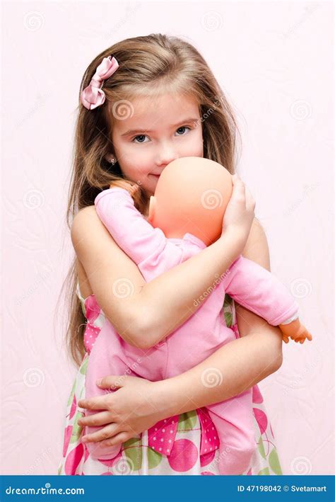 Cute Little Girl Holding And Embracing Her Doll Stock Photo Image Of