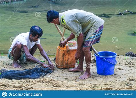 Tribal Fishermen Catch Fish With Fishing Nets In The Creek Tribals