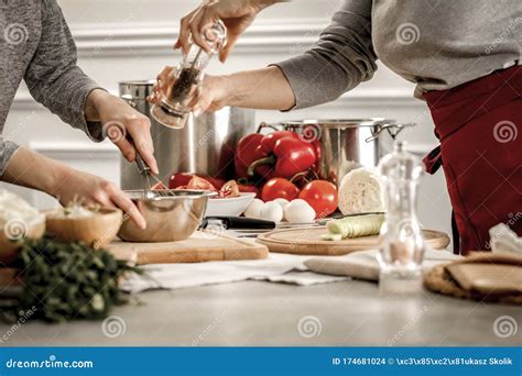 Female Hands Preparing Meals Preparation Of Dishes On A Wooden Kitchen