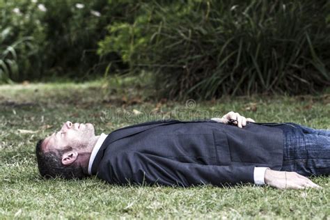 Sleeping Businessman Lying On Grass Textured Effect Stock Image