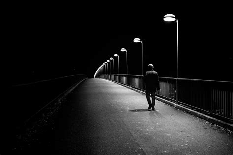 Grayscale Photo Of Man Walking On Pathway With Light Post On Side Hd