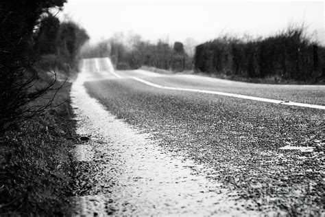 Standing Water On The Edge Of The Road On A Wet Irish Rural Road In