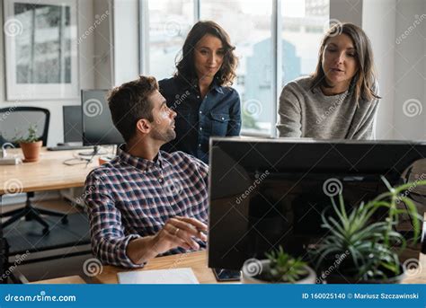 Group Of Diverse Young Designers Working Together On A Computer Stock