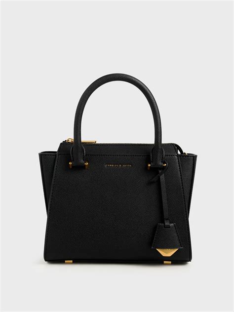 While faux leather does not last as long as real leather, it is easier to maintain the quality of the price of charles and keith bags range from rm111.90 to rm359.90. Black Structured Trapeze Bag | CHARLES & KEITH SG