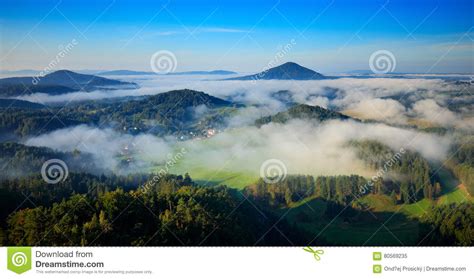 Czech Typical Summer Landscape With Fog Hills And Villages With Foggy